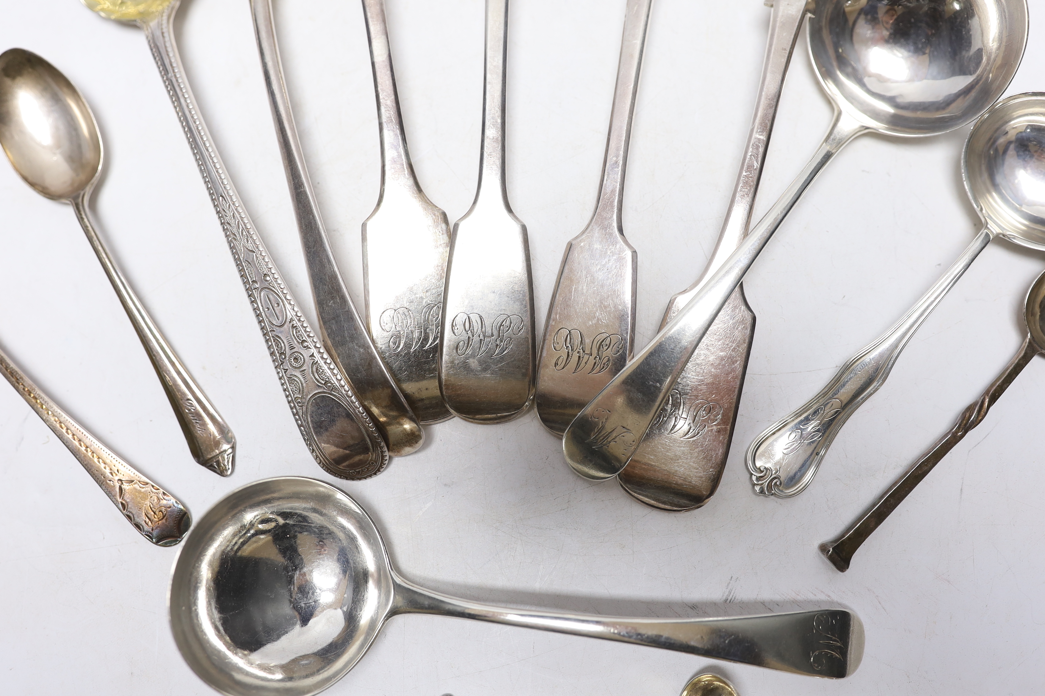 A George III Old English pattern berry spoon, maker George Smith (III), London 1777 and twelve other items of silver or sterling flatware, including a pair of Exeter fiddle pattern tablespoons, 18.3oz.